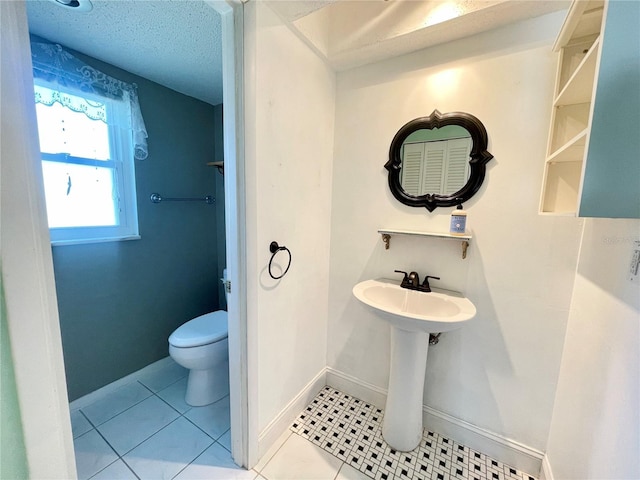 3122 Scranton St, Port Charlotte, FL 33952 - bathroom with toilet, baseboards, tile patterned flooring, and a textured ceiling