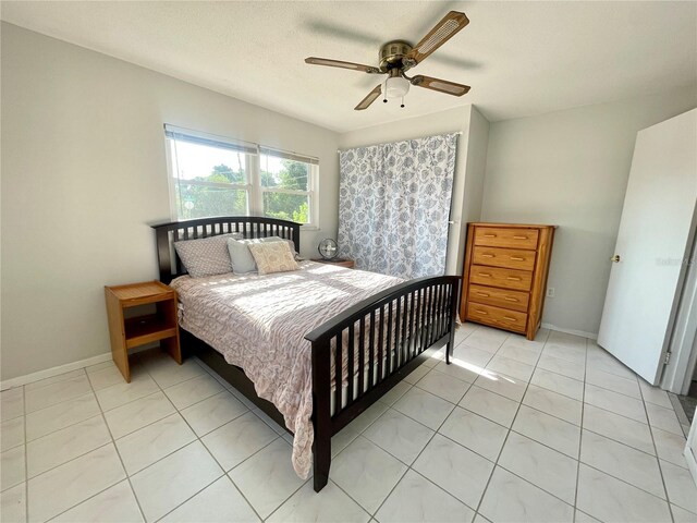 3122 Scranton St, Port Charlotte, FL 33952 - bedroom featuring light tile patterned flooring, a ceiling fan, and baseboards