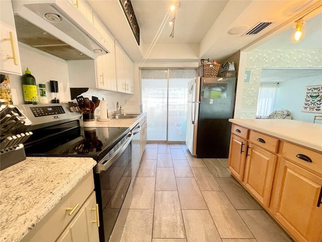 3122 Scranton St, Port Charlotte, FL 33952 - kitchen featuring appliances with stainless steel finishes, under cabinet range hood, a sink, and light brown cabinetry