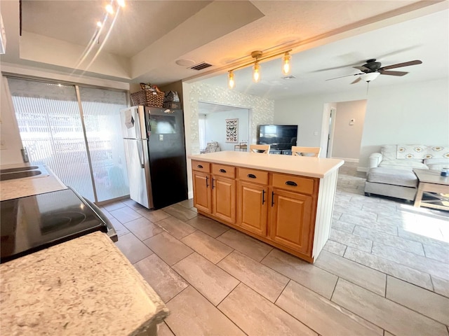 3122 Scranton St, Port Charlotte, FL 33952 - kitchen with freestanding refrigerator, light countertops, electric stove, open floor plan, and a ceiling fan