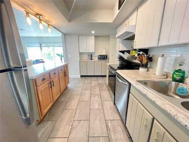 3122 Scranton St, Port Charlotte, FL 33952 - kitchen with under cabinet range hood, appliances with stainless steel finishes, light countertops, and backsplash