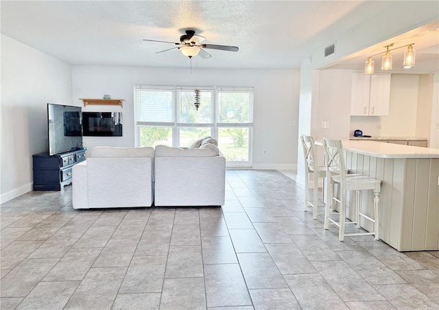 3122 Scranton St, Port Charlotte, FL 33952 - living area with a ceiling fan, a textured ceiling, and light tile patterned floors