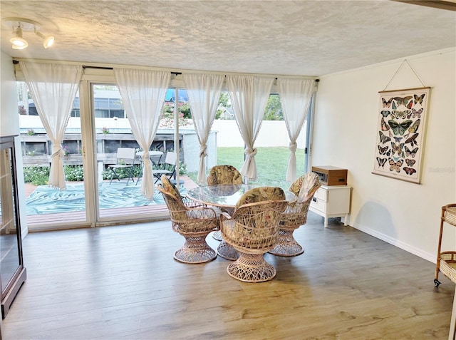 3122 Scranton St, Port Charlotte, FL 33952 - dining area with a textured ceiling, plenty of natural light, and wood finished floors
