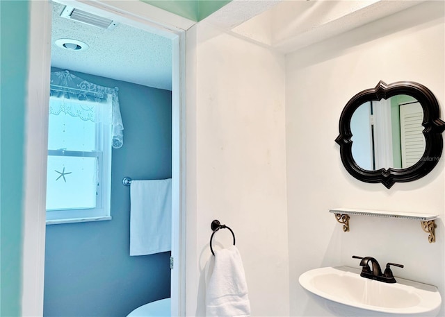 3122 Scranton St, Port Charlotte, FL 33952 - half bathroom featuring a sink and a textured ceiling