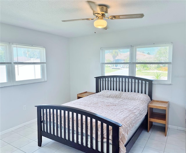 3122 Scranton St, Port Charlotte, FL 33952 - tiled bedroom featuring multiple windows, a ceiling fan, and a textured ceiling