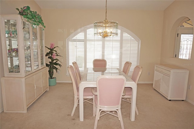 3398 Tripoli Blvd, Punta Gorda, FL 33950 - dining space featuring a chandelier, light colored carpet, baseboards, and arched walkways