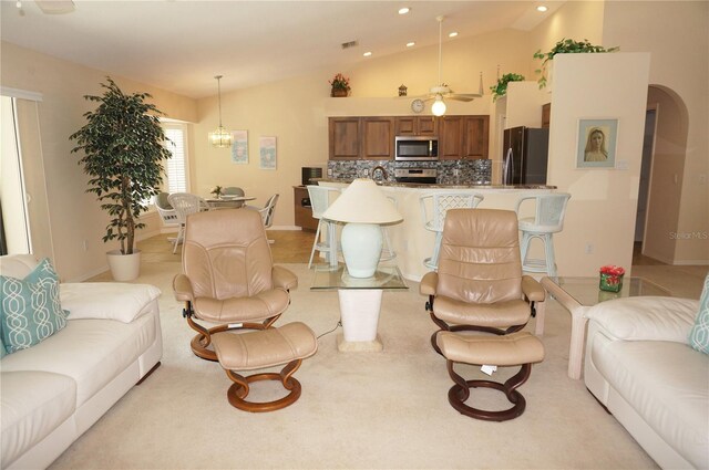 3398 Tripoli Blvd, Punta Gorda, FL 33950 - living area with vaulted ceiling, recessed lighting, light carpet, baseboards, and arched walkways