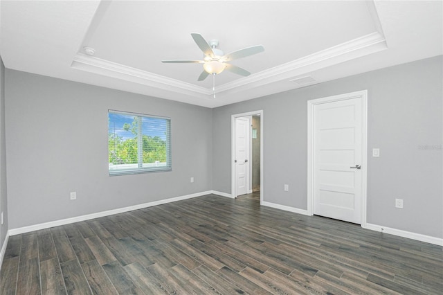 5532 Veracruz Ter, Port Charlotte, FL 33981 - empty room featuring a tray ceiling, ornamental molding, ceiling fan, dark wood-style floors, and baseboards
