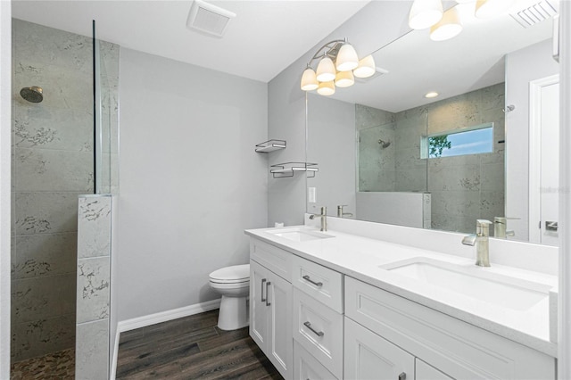 5532 Veracruz Ter, Port Charlotte, FL 33981 - full bathroom with double vanity, walk in shower, wood finished floors, and toilet