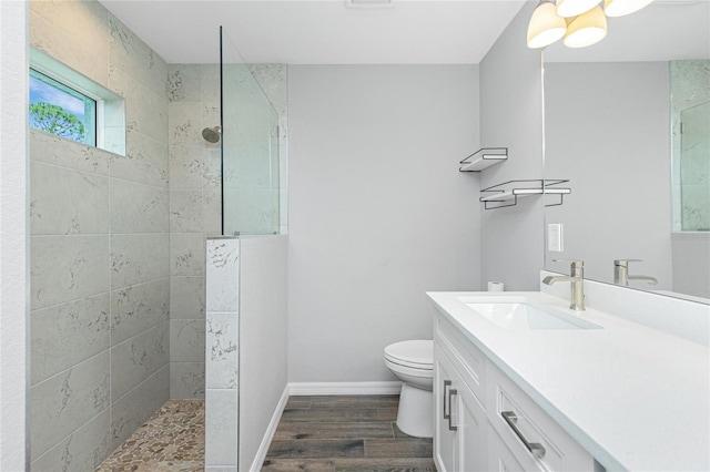 5532 Veracruz Ter, Port Charlotte, FL 33981 - bathroom featuring walk in shower, vanity, wood finished floors, toilet, and baseboards