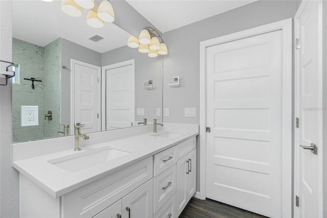 5532 Veracruz Ter, Port Charlotte, FL 33981 - full bathroom featuring double vanity, a chandelier, wood finished floors, and a tile shower