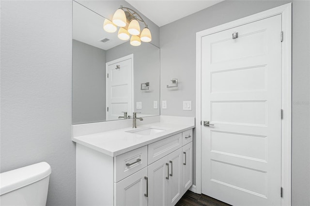 5532 Veracruz Ter, Port Charlotte, FL 33981 - bathroom featuring vanity, toilet, a chandelier, and wood finished floors