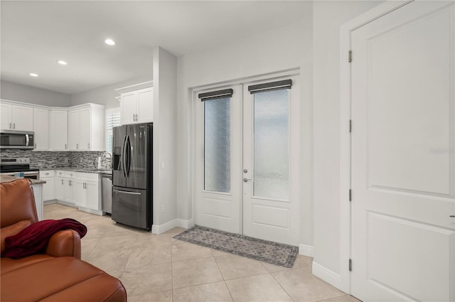3302 Palm Dr, Punta Gorda, FL 33950 - kitchen with stainless steel appliances, tasteful backsplash, white cabinets, and recessed lighting