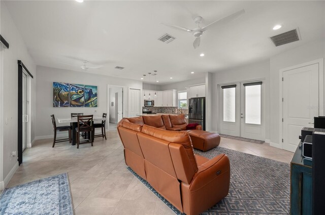 3302 Palm Dr, Punta Gorda, FL 33950 - living room with a ceiling fan, light tile patterned floors, recessed lighting, baseboards, and french doors