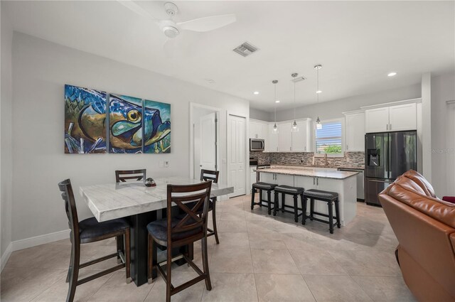 3302 Palm Dr, Punta Gorda, FL 33950 - dining room featuring recessed lighting, light tile patterned floors, ceiling fan, and baseboards