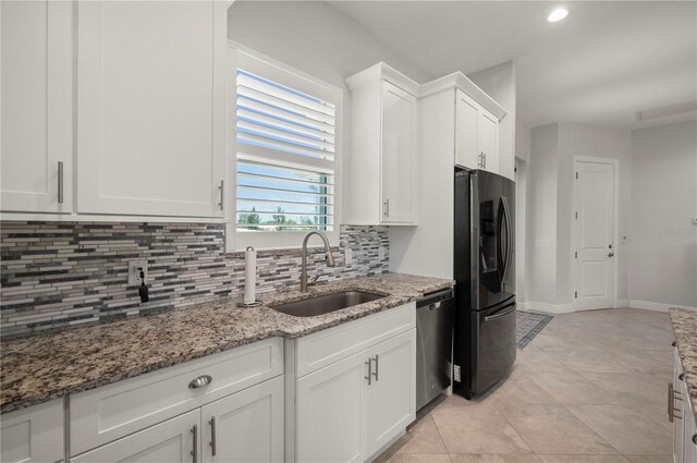 3302 Palm Dr, Punta Gorda, FL 33950 - kitchen with black refrigerator with ice dispenser, dishwasher, a sink, tasteful backsplash, and white cabinets