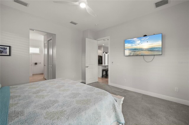 3302 Palm Dr, Punta Gorda, FL 33950 - carpeted bedroom with baseboards, a ceiling fan, and connected bathroom