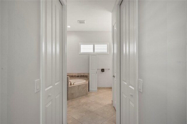 3302 Palm Dr, Punta Gorda, FL 33950 - bathroom featuring a bath, tile patterned flooring, and baseboards