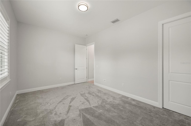 3302 Palm Dr, Punta Gorda, FL 33950 - unfurnished room featuring carpet flooring, baseboards, and plenty of natural light