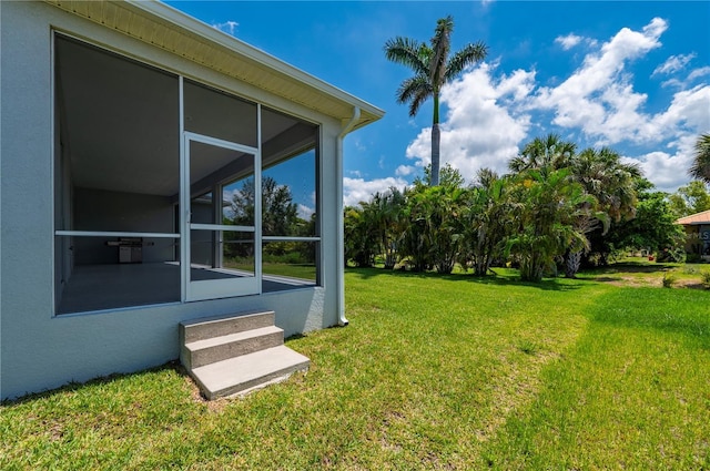 3302 Palm Dr, Punta Gorda, FL 33950 - view of grassy yard featuring a sunroom