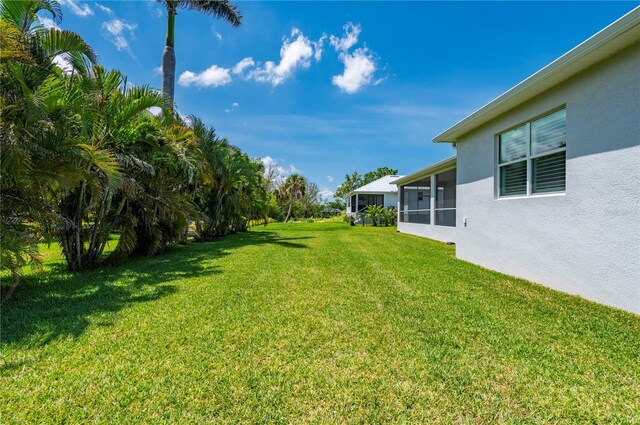 3302 Palm Dr, Punta Gorda, FL 33950 - view of green lawn featuring a sunroom
