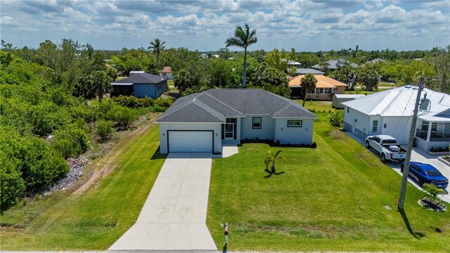 3302 Palm Dr, Punta Gorda, FL 33950 - single story home featuring concrete driveway, an attached garage, a front yard, and stucco siding
