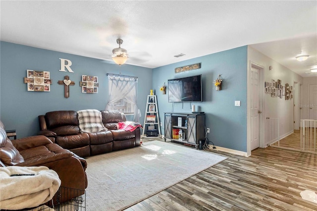 4702 Westwood Dr, Punta Gorda, FL 33982 - living area featuring wood finished floors, a ceiling fan, and baseboards