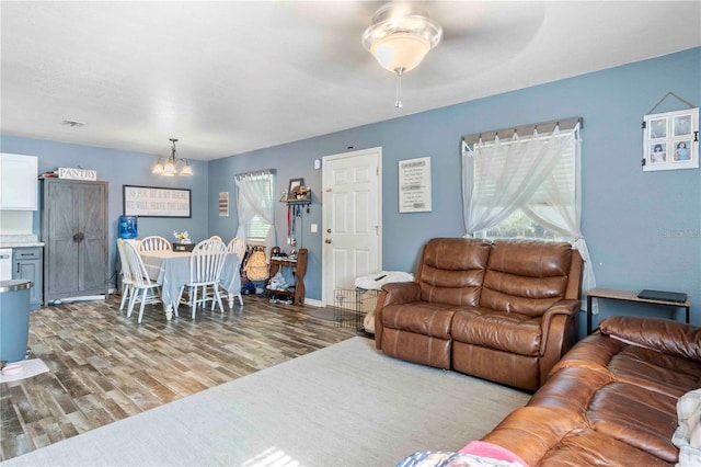 4702 Westwood Dr, Punta Gorda, FL 33982 - living room featuring a chandelier, wood finished floors, and ceiling fan