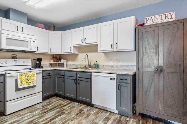 4702 Westwood Dr, Punta Gorda, FL 33982 - kitchen with white appliances, a sink, gray cabinets, and wood finished floors