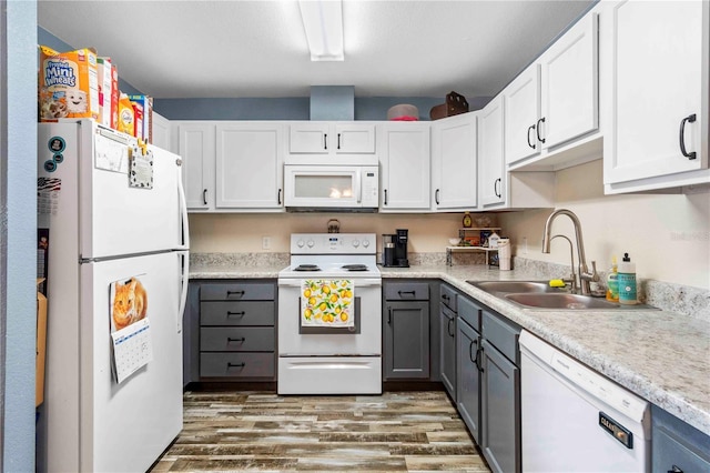 4702 Westwood Dr, Punta Gorda, FL 33982 - kitchen featuring white appliances, gray cabinetry, wood finished floors, light countertops, and a sink