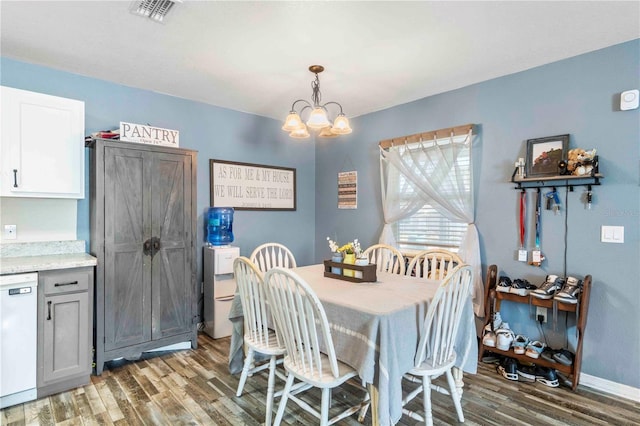 4702 Westwood Dr, Punta Gorda, FL 33982 - dining room with wood finished floors, a chandelier, and baseboards