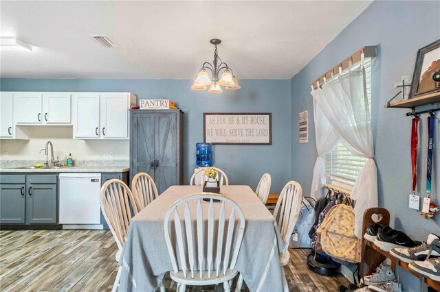 4702 Westwood Dr, Punta Gorda, FL 33982 - dining area with light wood-type flooring and a chandelier