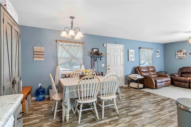 4702 Westwood Dr, Punta Gorda, FL 33982 - dining area with light wood finished floors, a chandelier, and baseboards