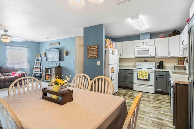 4702 Westwood Dr, Punta Gorda, FL 33982 - dining room with light wood-style flooring and a ceiling fan