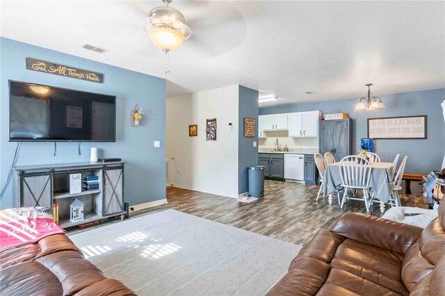 4702 Westwood Dr, Punta Gorda, FL 33982 - living area featuring a chandelier, wood finished floors, ceiling fan, and baseboards