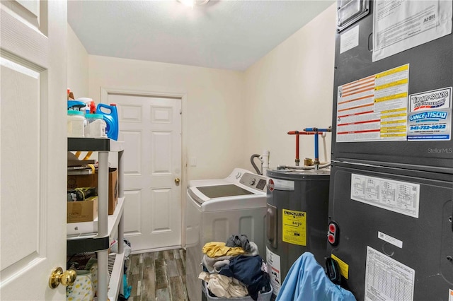 4702 Westwood Dr, Punta Gorda, FL 33982 - laundry room with electric water heater, wood finished floors, heating unit, and washer and clothes dryer