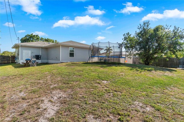 4702 Westwood Dr, Punta Gorda, FL 33982 - rear view of house with a trampoline and central air condition unit