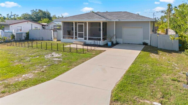 4702 Westwood Dr, Punta Gorda, FL 33982 - view of front of home with a sunroom, a garage, driveway, and a shingled roof