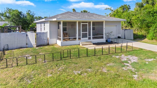 4702 Westwood Dr, Punta Gorda, FL 33982 - back of house featuring a gate, concrete driveway, an attached garage, a sunroom, and a shingled roof