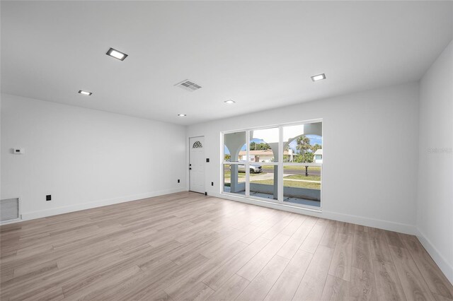 2166 Beacon Dr, Port Charlotte, FL 33952 - empty room with light wood finished floors and baseboards