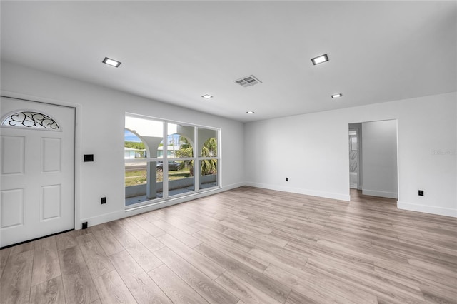 2166 Beacon Dr, Port Charlotte, FL 33952 - unfurnished living room featuring baseboards, light wood-style floors, and recessed lighting