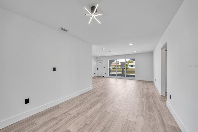 2166 Beacon Dr, Port Charlotte, FL 33952 - unfurnished living room with light wood-style floors, baseboards, and recessed lighting