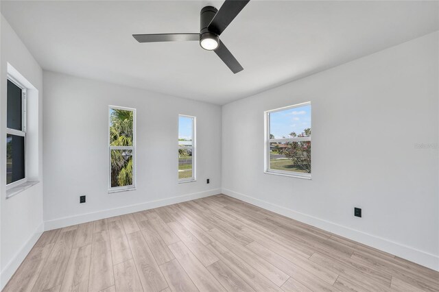 2166 Beacon Dr, Port Charlotte, FL 33952 - empty room featuring healthy amount of natural light, ceiling fan, and light wood-style floors