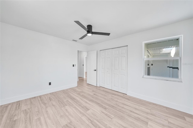 2166 Beacon Dr, Port Charlotte, FL 33952 - unfurnished bedroom featuring wood finished floors, baseboards, a closet, and ceiling fan