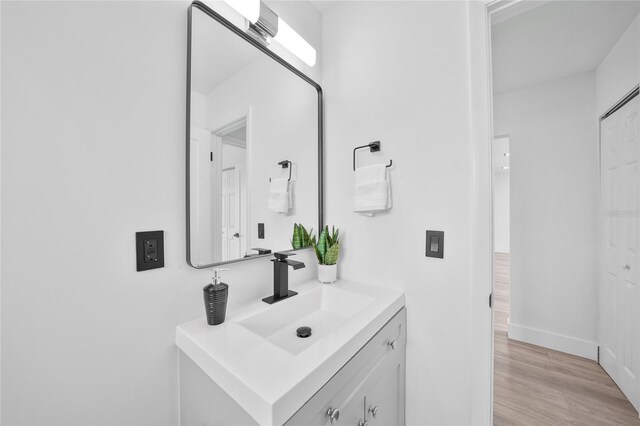 2166 Beacon Dr, Port Charlotte, FL 33952 - bathroom featuring vanity, wood finished floors, and baseboards