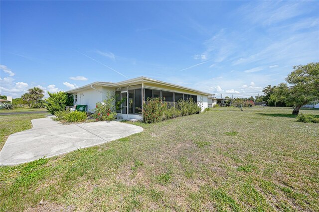 2166 Beacon Dr, Port Charlotte, FL 33952 - view of green lawn featuring a sunroom