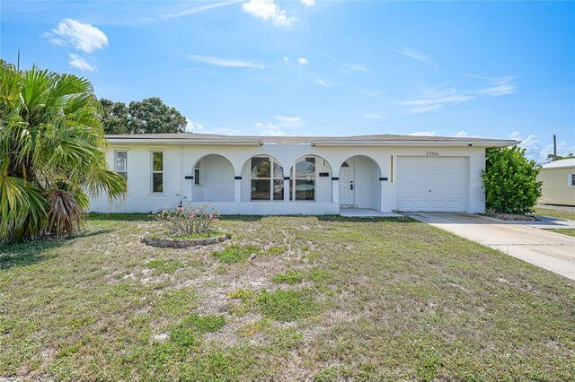 2166 Beacon Dr, Port Charlotte, FL 33952 - ranch-style house featuring concrete driveway, stucco siding, an attached garage, and a front lawn