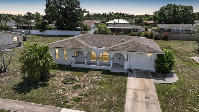 2166 Beacon Dr, Port Charlotte, FL 33952 - ranch-style home featuring roof with shingles, a garage, concrete driveway, and a front lawn