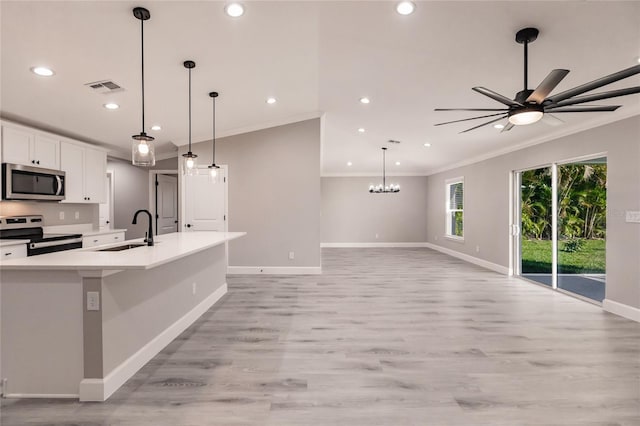16280 Minorca Dr, Punta Gorda, FL 33955 - kitchen featuring appliances with stainless steel finishes, a sink, crown molding, light wood-style floors, and white cabinets