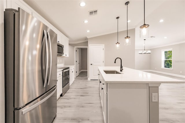 16280 Minorca Dr, Punta Gorda, FL 33955 - kitchen with stainless steel appliances, a sink, ornamental molding, white cabinets, and an island with sink
